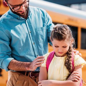 Stranger Man Talking with Child by School Bus